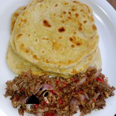 A picture of Paratha with onion and fish sauce.