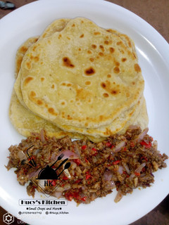 A picture of Paratha with onion and fish sauce.