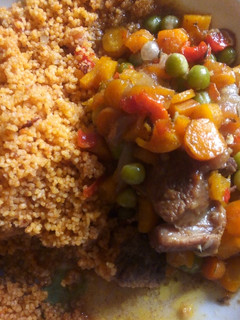 A picture of Jollof cous cous and carrot sauce.