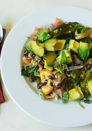 A picture of Quinoa with black beans and avocado- topped with Avocado cashew dressing.