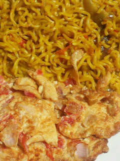 A picture of Turmeric noodles and fried egg.