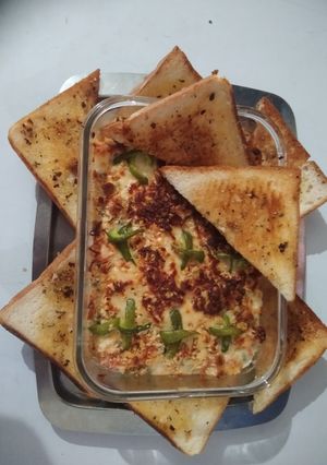 A picture of Veg Au gratin and Garlic herb toast.