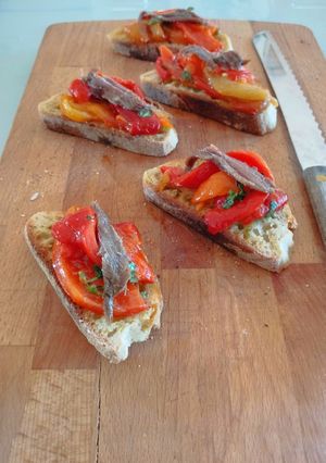 A picture of Toasted Bread with Roasted Peppers and Anchovy Fillets.
