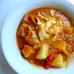 A picture of Potatoes and Poached Eggs in a Coconut Curry.
