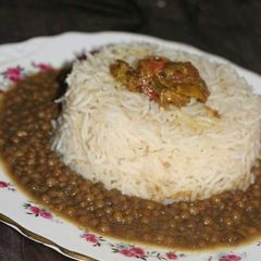 A picture of Masar dal with tarka rice & mix acahr.