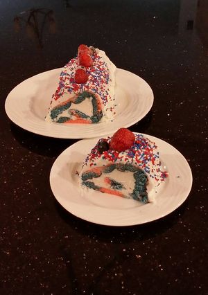 A picture of Patriotic Vanilla Cake Roll with Whipped White Chocolate Ganache Filling and Frosting.