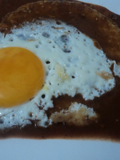 A picture of Sunny-Side-Up Egg on Tortilla with Tequila Ranchero Mole.