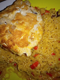 A picture of Noodles and fried egg.