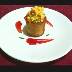A picture of Elevated Pancake with Scrambled Buttered Eggs and Homemade Syrup.