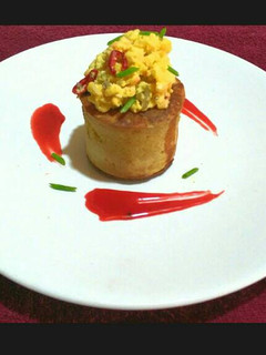 A picture of Elevated Pancake with Scrambled Buttered Eggs and Homemade Syrup.