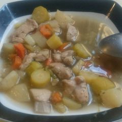A picture of Vegetables and chicken soup.