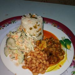 Buttered Veggie Rice, Palm oil egg sauce,baked beans and salad A picture of Buttered Veggie Rice, Palm oil egg sauce,baked beans and salad.