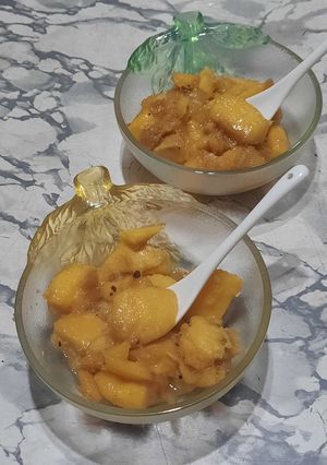 Una foto de Mango flambeado con coco