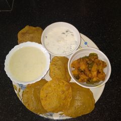 A picture of Milk custard with Puri sabji raita.