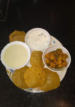 A picture of Milk custard with Puri sabji raita.