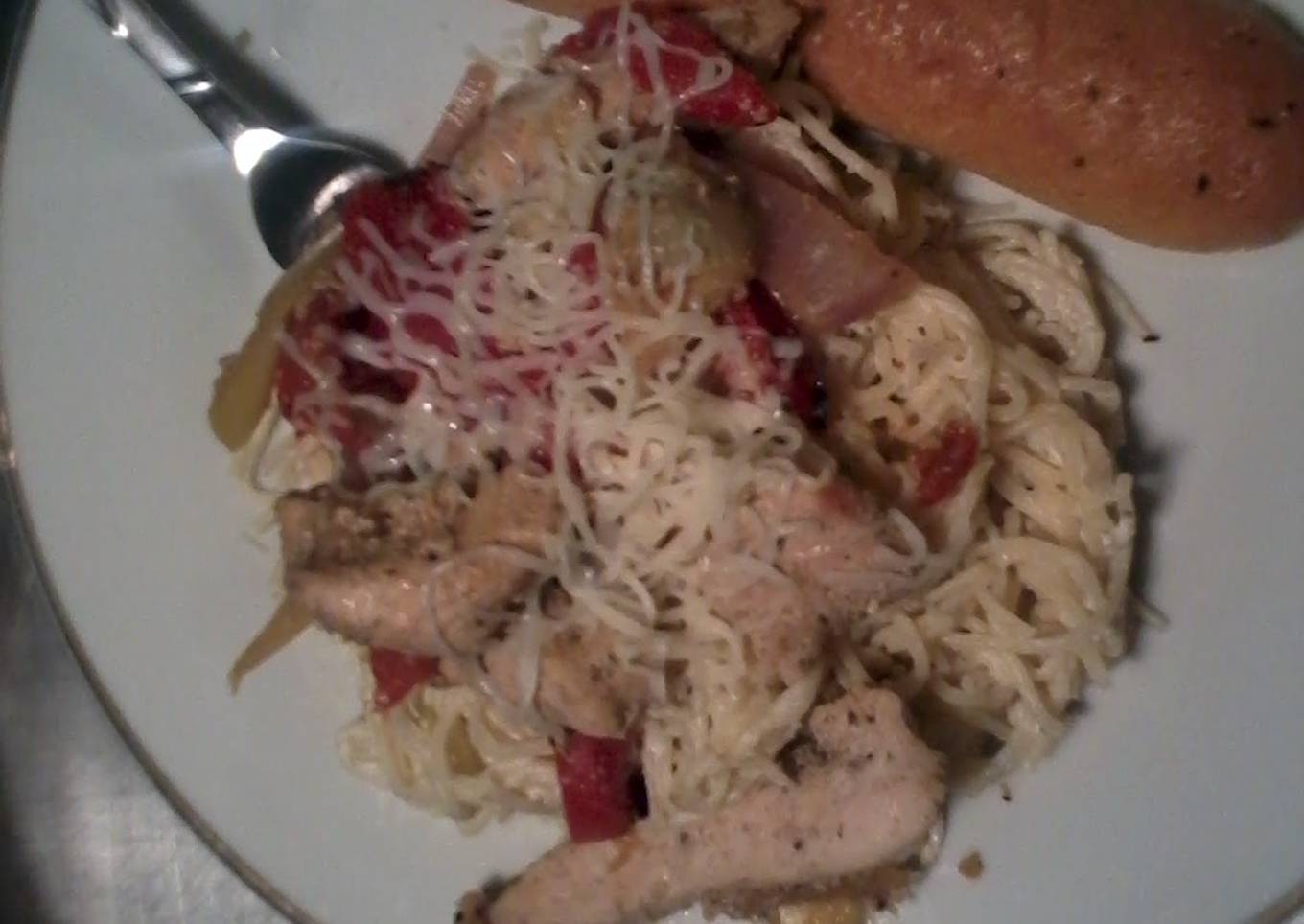 italian chicken with angel hair pasta in a creamy artichoke primavera