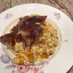 A picture of Butternut squash risotto with crispy coppa.