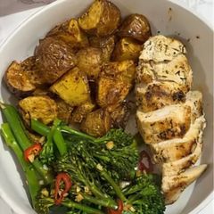 A picture of Garlic chicken, potatoes and greens.