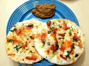A picture of onion tomato uttapam