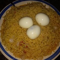 A picture of Indomie with boiled eggs.