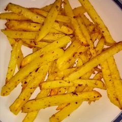 A picture of French fries in air fryer.