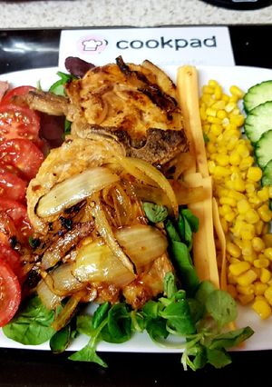 A picture of My Peri Peri Pork Chops and Pepper flakes with onions & Salad 😍.