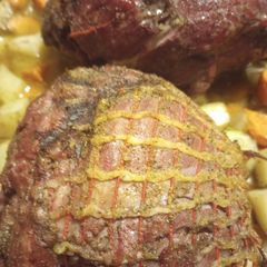 A picture of Smokey Lamb on a Grill with Veggies.
