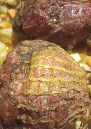 A picture of Smokey Lamb on a Grill with Veggies.