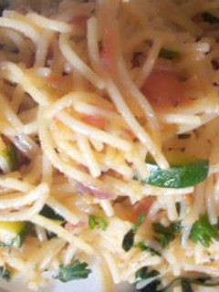 A picture of Stir fried spaghetti with cheese.