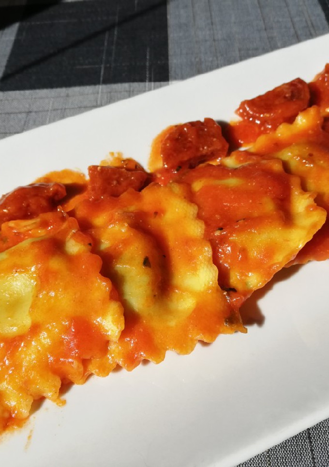 Una foto de Ravioli 🥟 rellenos de requesón y espinacas en salsa
