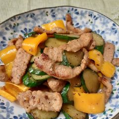 A picture of Cucumber, yellow pepper and pork stir fry.