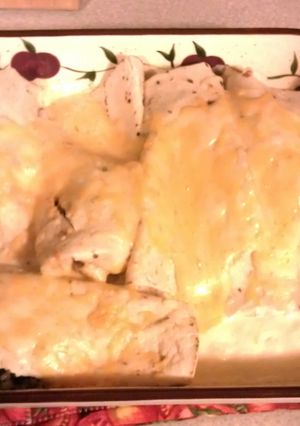 A picture of spinach mushroom n cheese enchiladas with white sauce.