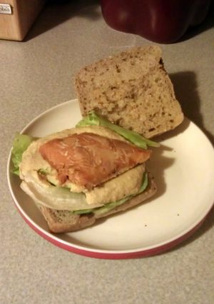 A picture of smoked salmon n hummus sandwich.