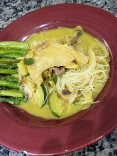 A picture of Chicken Curry with Rice Noodles and Oven Roasted Asparagus.