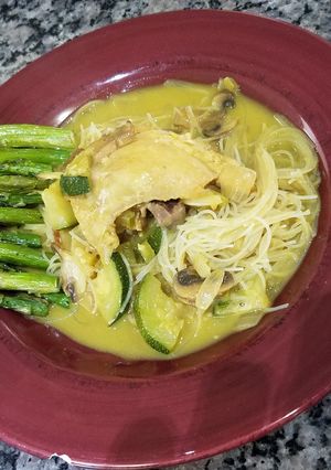 A picture of Chicken Curry with Rice Noodles and Oven Roasted Asparagus.
