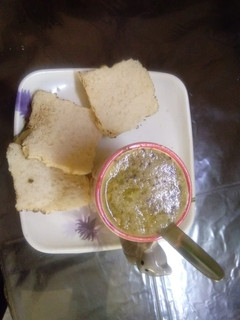 A picture of Chicken soup with bread toast.