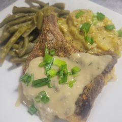 A picture of Fried Pork Chop with Mushroom Wine Cream Sauce.