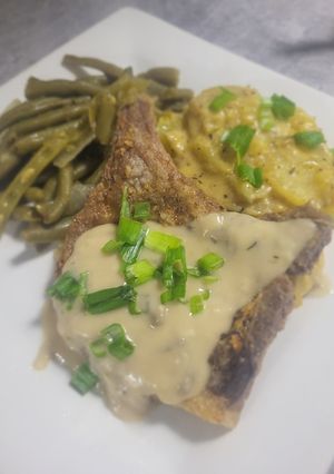 A picture of Fried Pork Chop with Mushroom Wine Cream Sauce.