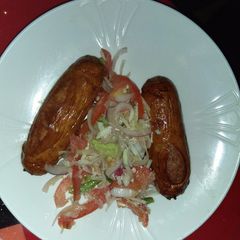 A picture of Beef sausages with salad.