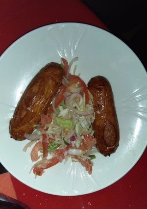 A picture of Beef sausages with salad.