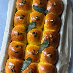 A picture of Kabocha Dinner Rolls with Sage Infused Brown Butter.
