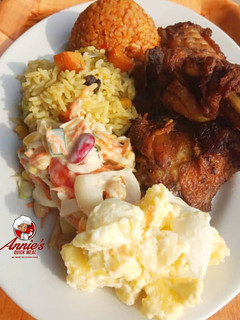 A picture of Fried rice,Jollof rice,Fried chicken, Potatoe Salad and coleslaw.