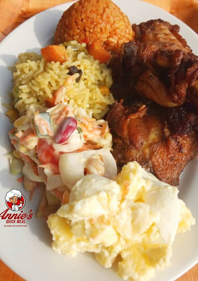 A picture of Fried rice,Jollof rice,Fried chicken, Potatoe Salad and coleslaw.