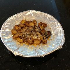 A picture of Crispy Cheese Topped Baby Potatoes.