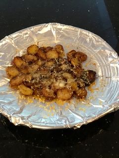 A picture of Crispy Cheese Topped Baby Potatoes.