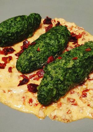 A picture of Gnudi with Ricotta Cream and Sun-Dried Tomatoes.