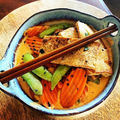 Thai Red Curry Coconut with Pan Fried Tofu, Snap Peas & Carrots over Rice A picture of Thai Red Curry Coconut with Pan Fried Tofu, Snap Peas & Carrots over Rice.