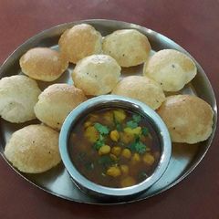 A picture of Bela kachori with aloo chole ki sabzi.