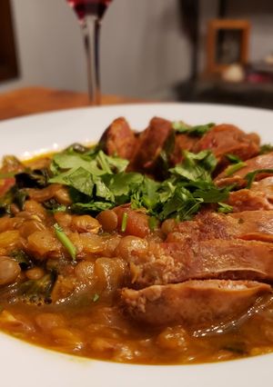 A picture of Merguez Sausage and Cumin Lentils with Dandelion Greens.