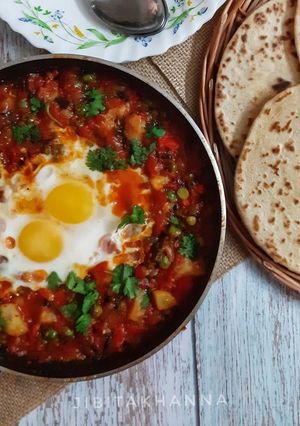 A picture of Shakshuka (In my style- Poached eggs in tomato and veggie gravy).